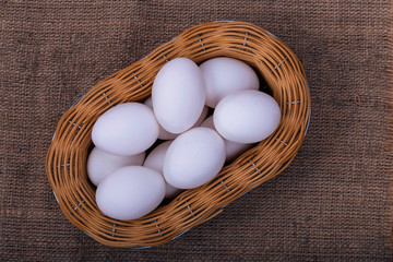 fresh white chicken eggs in a basket as food background