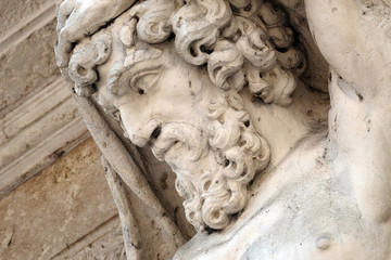 Fototapeta premium Statue of Hercules at the entrance to the 18th century Palazzo Vescovile (Bishops Palace) in the historical center of Mantua, Italy 