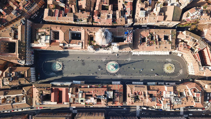 Fototapeta na wymiar Aerial drone view of iconic landmark Piazza Navona Square featuring Fountain of the Four Rivers with an Egyptian obelisk and Sant Agnese Church in the heart of Rome, Italy