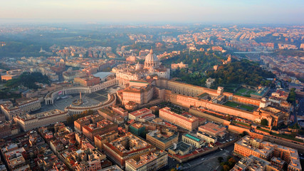 Aerial drone view of Saint Peter's square in front of world's largest church - Papal Basilica of St. Peter's, Vatican - an elliptical esplanade created in the mid seventeenth century, Rome, Italy