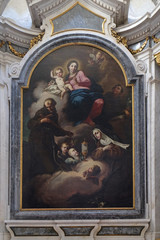 Virgin and Child adored by St. Francis of Assisi, Clare and Anthony of Padua, altarpiece in Clare d'Assisi chapel, Mantua Cathedral dedicated to Saint Peter, Mantua, Italy  - obrazy, fototapety, plakaty