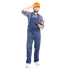 Young man builder industry worker hardhat with a notebook and pen in hand on white background isolation