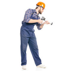 Young man builder industry worker hardhat with a silicone gun on white background isolation