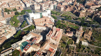 Fototapeta na wymiar Aerial drone view from Roman Forum one of the main tourist attractions which was build in ancient times as the site of triumphal processions and elections next to Colosseum, Rome, Italy