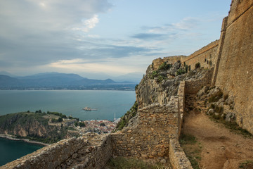 Fototapeta na wymiar high rock castle wall ruins and sea bay beautiful medieval place and calm evening landscape