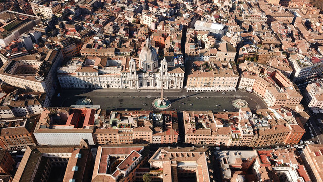 Aerial drone view of iconic landmark Piazza Navona Square featuring Fountain of the Four Rivers with an Egyptian obelisk and Sant Agnese Church in the heart of Rome, Italy