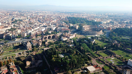 Fototapeta na wymiar Aerial drone view from Roman Forum one of the main tourist attractions which was build in ancient times as the site of triumphal processions and elections next to Colosseum, Rome, Italy