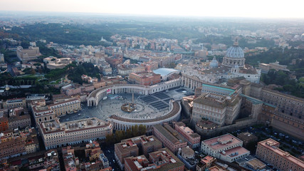 Aerial drone view of Saint Peter's square in front of world's largest church - Papal Basilica of St. Peter's, Vatican - an elliptical esplanade created in the mid seventeenth century, Rome, Italy