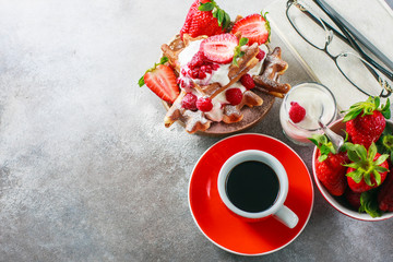 Belgian waffles with creem, raspberries, strawberriesand coffee , top view with copy space.