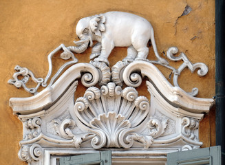Beautiful house facade with carved stone animals in Mantua, Italy 