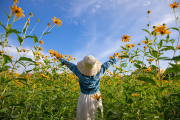 Children in the field yellow flowers yellow. Dutch girl in white hat