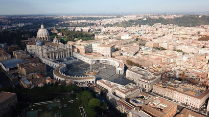 Aerial drone view of Saint Peter's square in front of world's largest church - Papal Basilica of St. Peter's, Vatican - an elliptical esplanade created in the mid seventeenth century, Rome, Italy