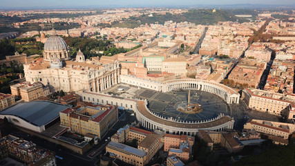 Fototapeta premium Aerial drone view of Saint Peter's square in front of world's largest church - Papal Basilica of St. Peter's, Vatican - an elliptical esplanade created in the mid seventeenth century, Rome, Italy