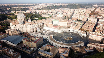 Fototapeta premium Aerial drone view of Saint Peter's square in front of world's largest church - Papal Basilica of St. Peter's, Vatican - an elliptical esplanade created in the mid seventeenth century, Rome, Italy