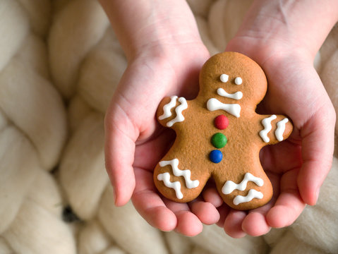 Hands holding Christmas gingerbread cookies