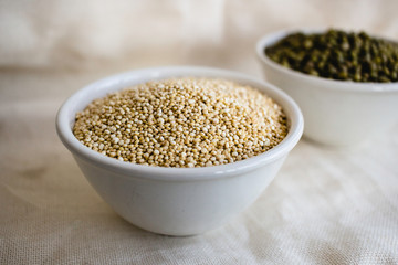 Quinoa in white cup. Raw white quinoa