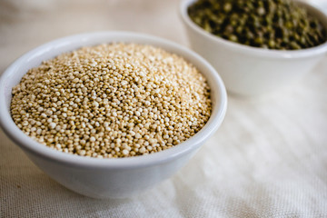 Quinoa in white cup. Raw white quinoa