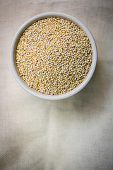 Quinoa in white cup. Raw white quinoa