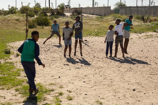 Kids playing football in the ground