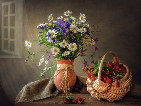 Still life with bouquet of summer wildflowers and strawberries