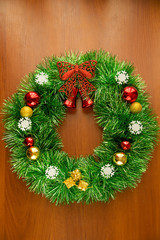 Fototapeta na wymiar Christmas decorated wreath on wooden background 