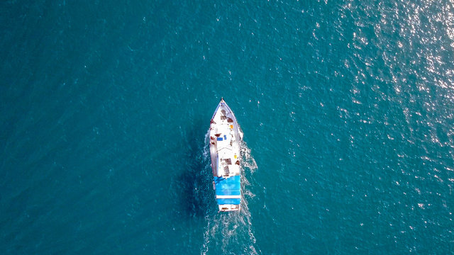 Aerial Image Of A Small Fishing Boat Roaring Along The Mediterranean Sea