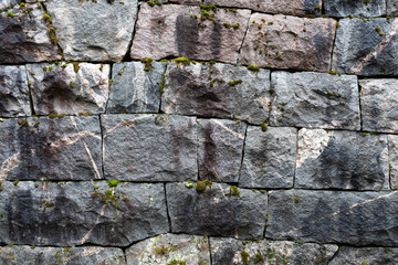 Old handmade rock wall with neatly fitted solid blocks of rock