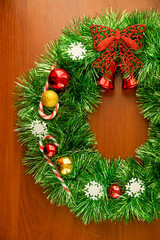 Christmas decorated wreath on wooden background 