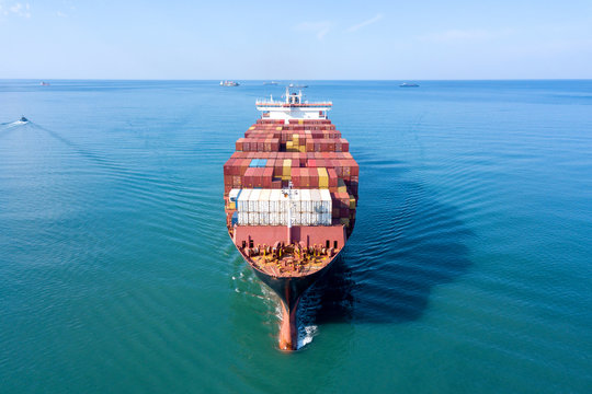 Large container ship at sea - Low angle aerial image.