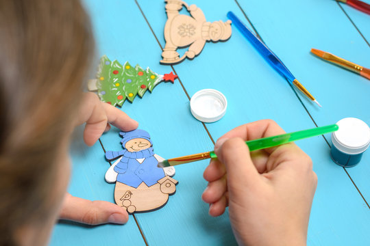 child draws on a wooden toy. Children's creativity