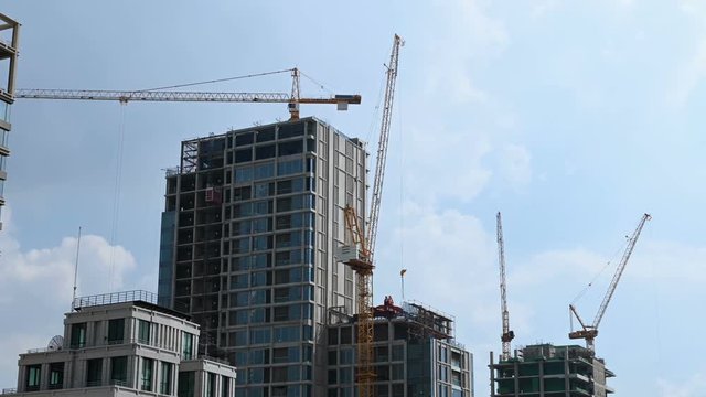 Timelapse of working tower cranes at construction site
