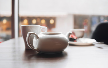 On the table stands a cup of tea. On the background of the street.