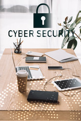 close up view of cyber security sign, workplace with laptop, coffee to go and notebook