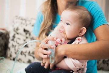 Mom makes inhalation of the child, holding hands