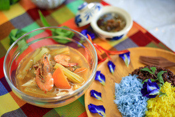 Sour curry with vegetable and shrimp serve with herb cooked rice. Thai food set recipe.