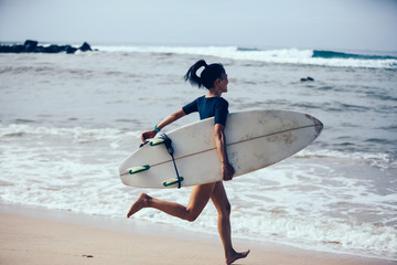 Surfer woman with surfboard the beach 