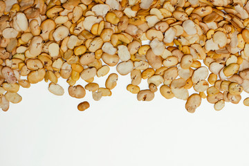 Yellow raw split broad beans on white background. Food pattern. Texture. 