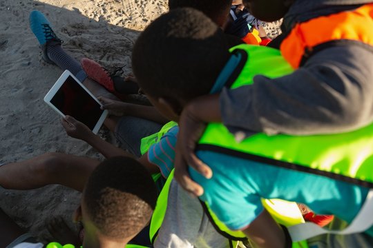 Kids using digital tablet in the ground