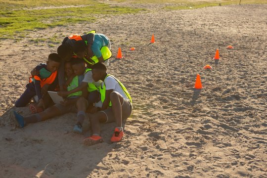 Kids using digital tablet in the ground