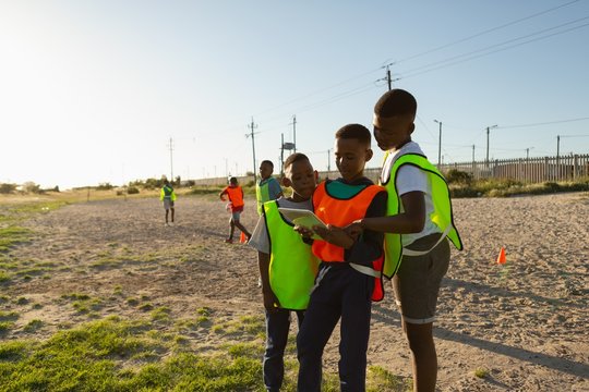 Kids using digital tablet in the ground