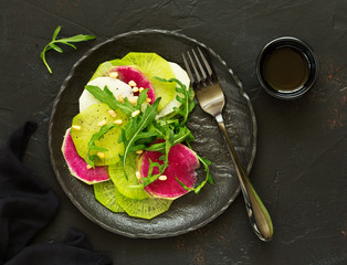 Fresh salad from three grades of radish, with arugula.
