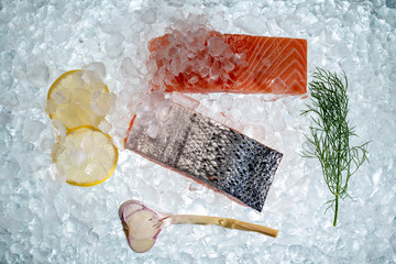 Salmon fish with vegetable  on ice on flatlay