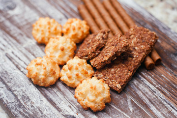 Mix of sweets. on wood table. Christmas treat. Chocolate wafer rolls, coconut  cakes, cocoa cereal bar. 