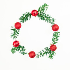 Christmas frame made of fir branches and red balls on white background. Festive background. Flat lay, top view