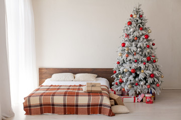 Christmas tree in the bedroom with bed and gifts holiday new year winter postcard