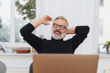 Satisfied businessman stretching his arms