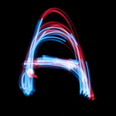 Letter A of the alphabet made from neon sign. The blue light image, long exposure with colored...
