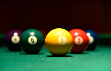 Billiard balls and cue on the pool table