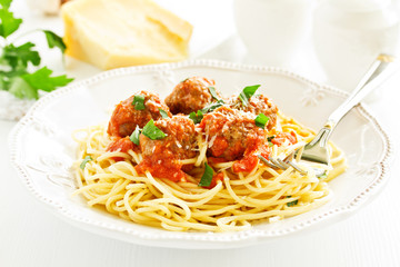 Egg tagliatelle with meatballs in tomato sauce.