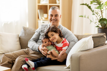 family, fatherhood and people concept - happy father with preteen and baby son at home